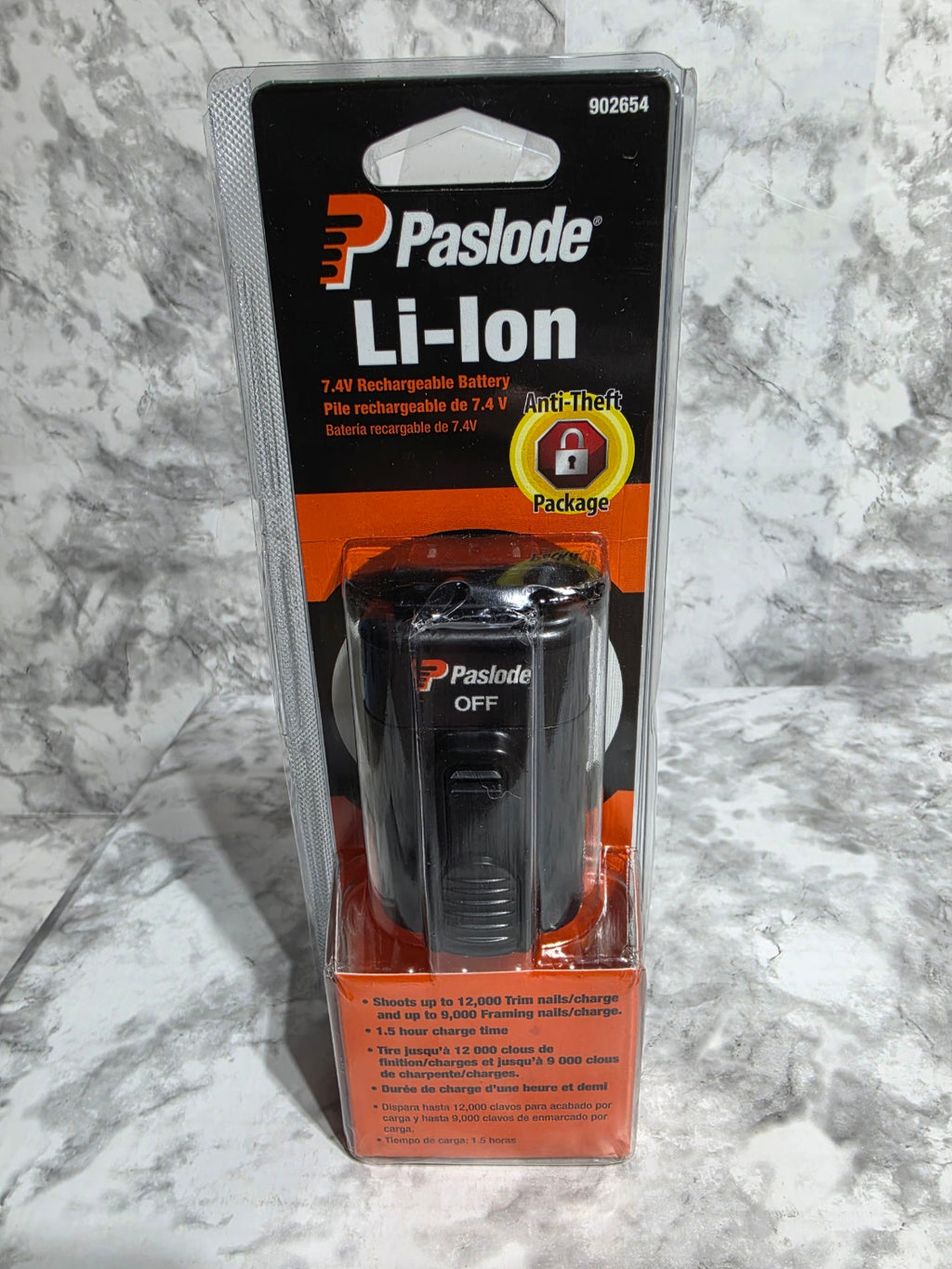 Paslode Li-ion battery in packaging on a marble surface