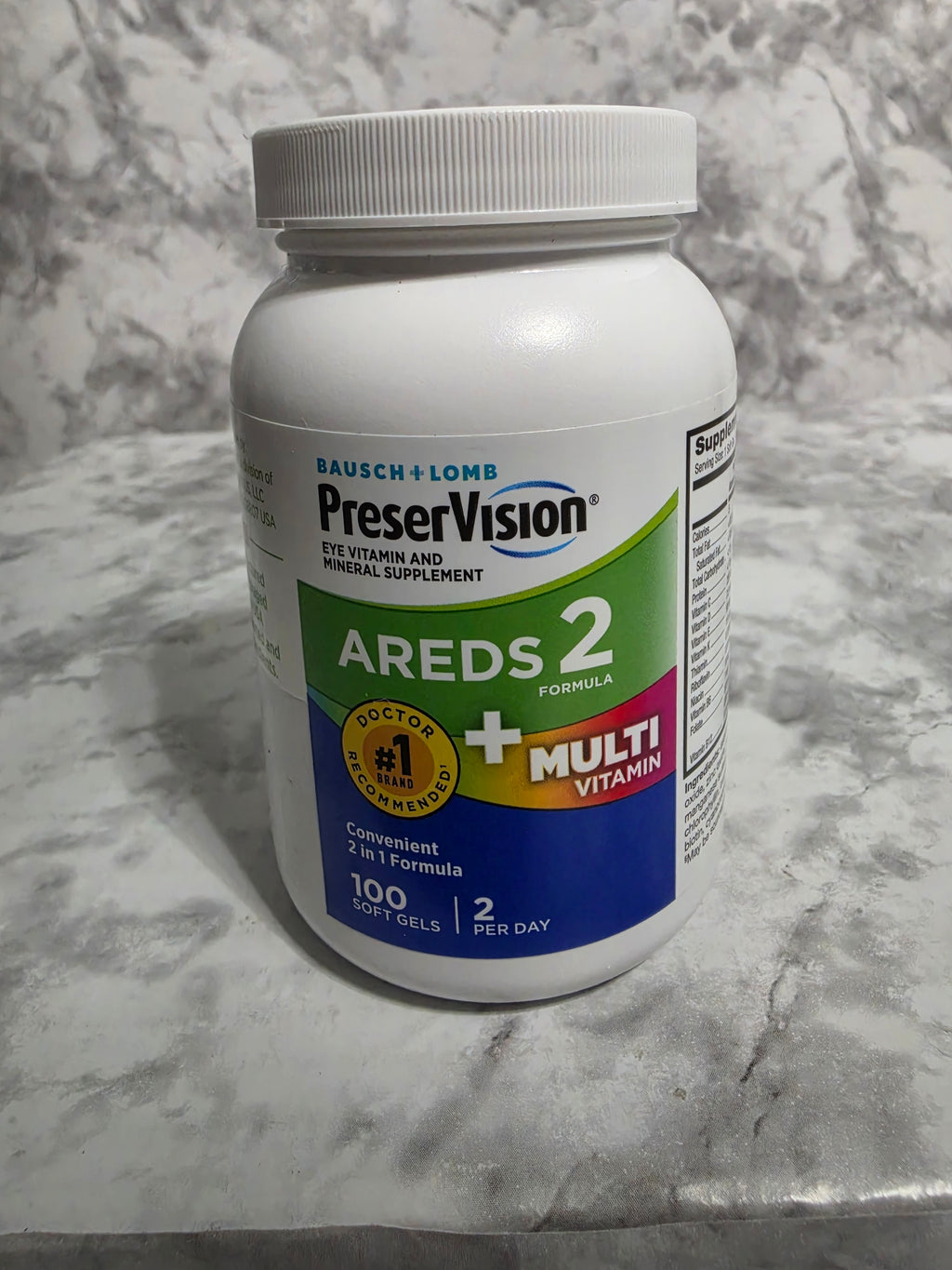 Preservision AREDS 2 vitamin supplement bottle on a marble surface