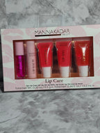 Set of lip care products in a box with 'Mannakadar' branding on a marble surface.