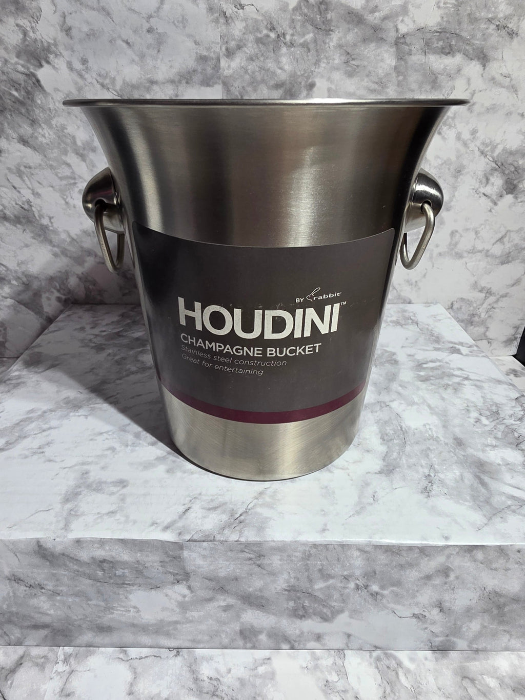 Stainless steel champagne bucket with Houdini branding on a marble surface