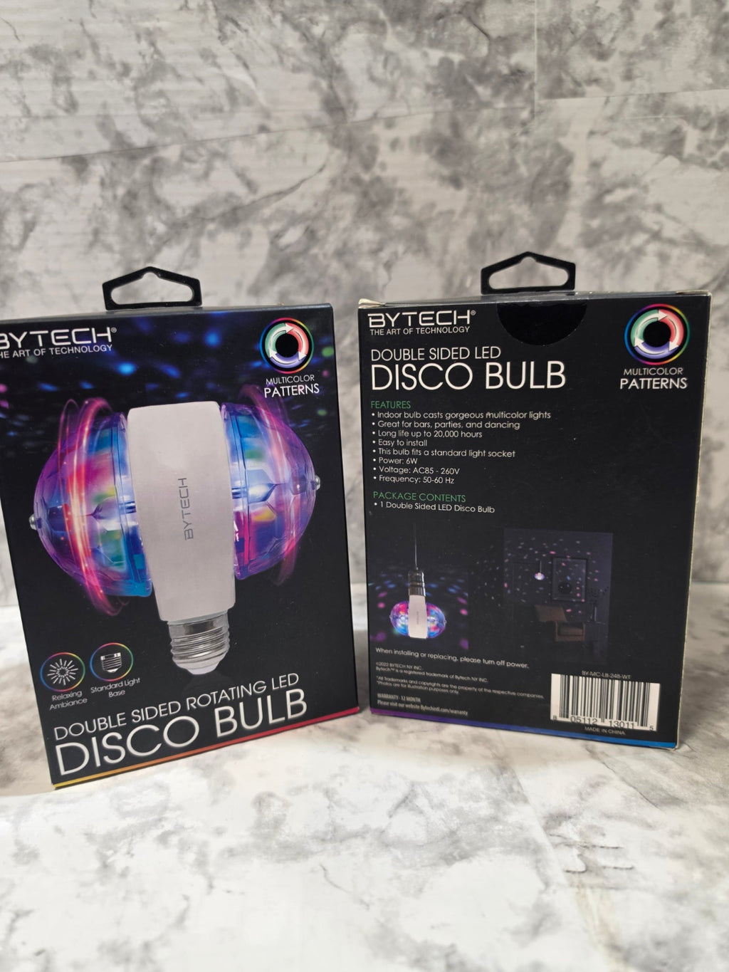 Two Extech disco bulb packages on a marble surface