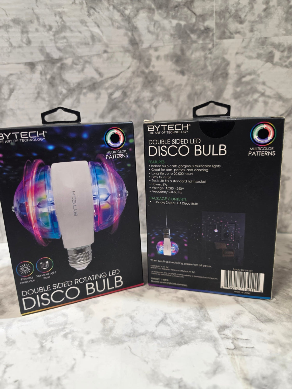 Two Extech disco bulb packages on a marble surface