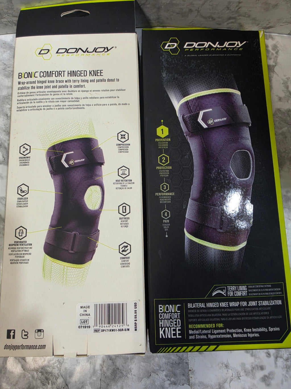 Two boxes of Donjoy Bionic Comfort Hinged Knee brace on a gray surface.