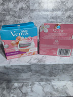 Two boxes of Venus women's razors on a marble surface