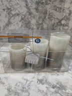 Two candles in a clear packaging on a marble surface