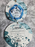 Two round containers with blue and white design on a gray marble surface