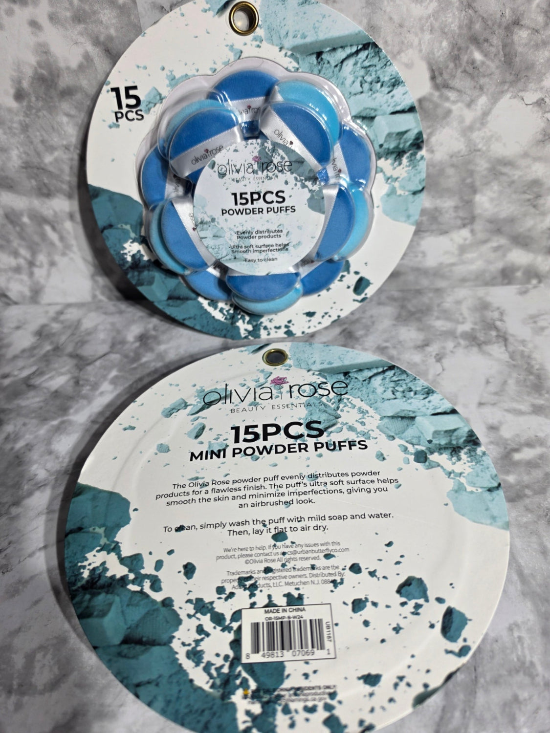Two round containers with blue and white design on a gray marble surface