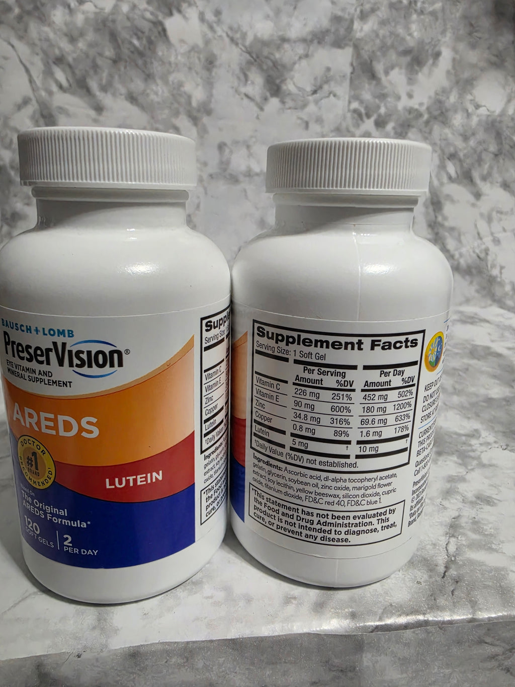 Two supplement bottles on a marble surface