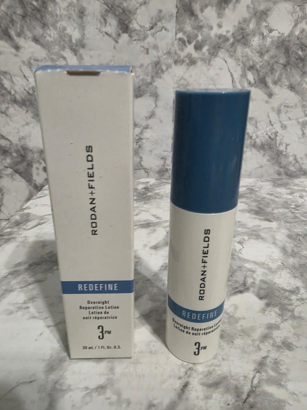 Two tubes of Roan + Fields Blueefine on a marble surface