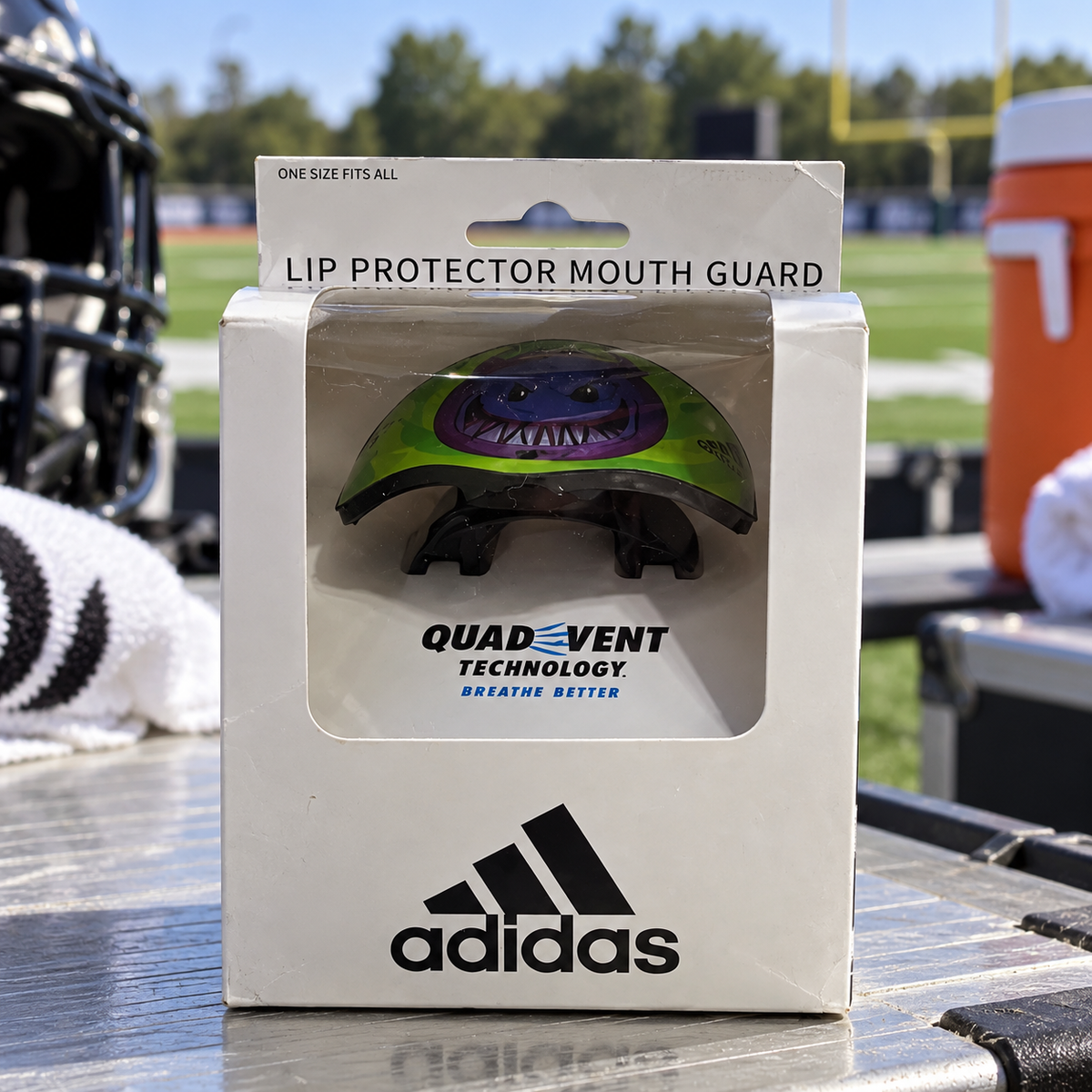 AI-styled Adidas Big Mood Demon AD-LP-910 mouthguard in original packaging at a sideline table