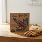 AI-generated lifestyle scene of one boxed Adventure Is Out There orange 11-in-1 multi-tool on a garage workbench; gloves and tray not included.