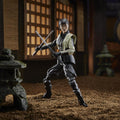G.I. Joe Classified Series Akiko figure posed with two crossed blades in a miniature courtyard.