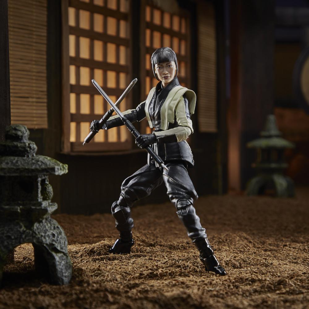 G.I. Joe Classified Series Akiko figure posed with two crossed blades in a miniature courtyard.