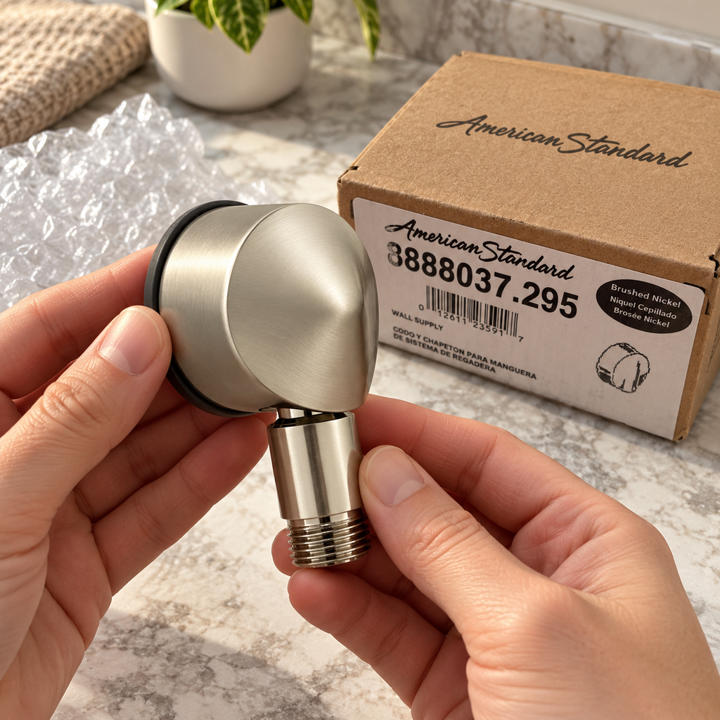 American Standard 8888.037.295 brushed nickel wall supply elbow, handheld inspection, AI-assisted illustration