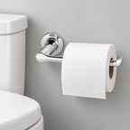 Studio S chrome toilet paper holder with a roll beside a toilet