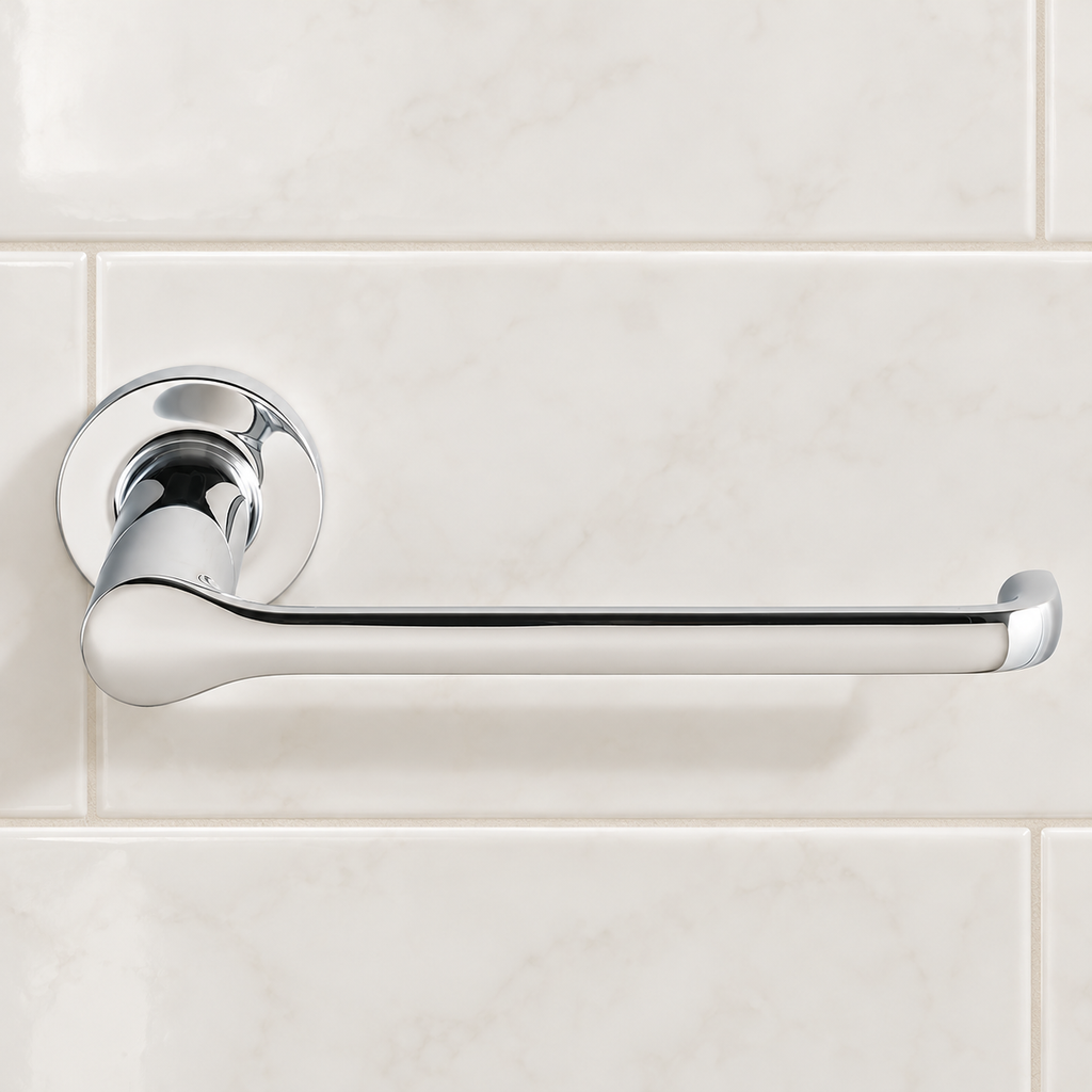 Polished chrome Studio S toilet paper holder mounted on light bathroom tile
