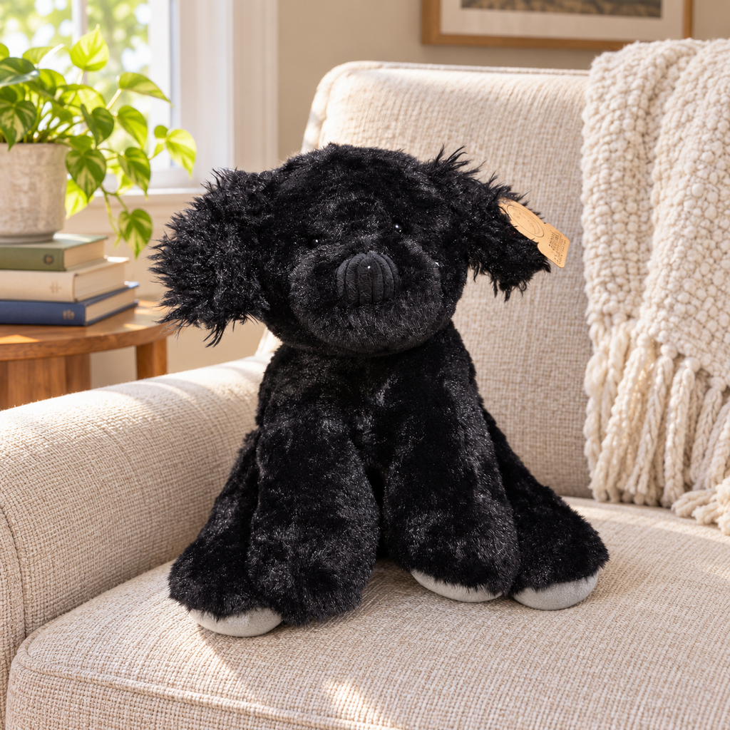 AI-generated context: the charcoal-black Animal Adventure puppy plush on a reading-nook armchair; books and furnishings not included