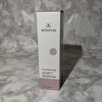 AI-generated contextual image of Arbonne TrueSmooth Apple Vinegar Hair Rinse 5 fl oz boxed product on a neutral marble surface