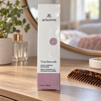 AI lifestyle illustration of the closed Arbonne TrueSmooth Apple Vinegar Hair Rinse 5 fl oz carton on a dresser; comb and background items are props.