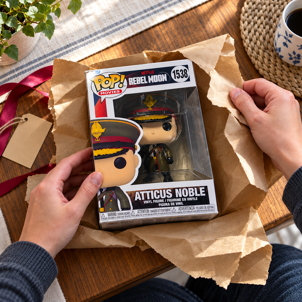 Boxed Funko Pop! Atticus Noble #1538 being unwrapped from gift paper.