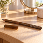 Mary Kay Bahama Blue eyeliner pencil and cap on a sunlit wooden vanity