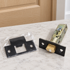 AI illustration: Detail of Baldwin 5510.102 latch and bagged dark T-strike near a light wood interior door