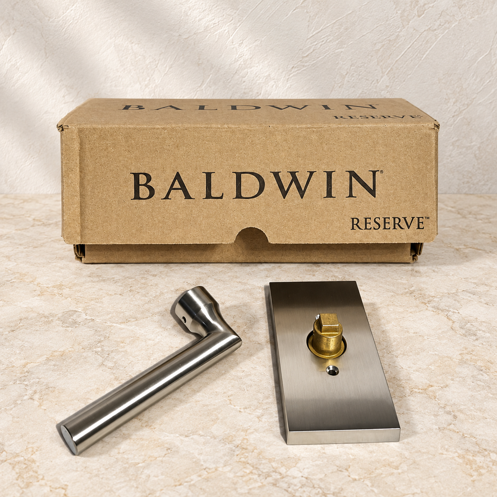 AI-generated product illustration: Baldwin Reserve Tube lever and separate rectangular rose with original box on a stone surface; not the actual stock photograph.