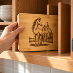Horse and barn engraved bamboo board being placed upright in a cupboard