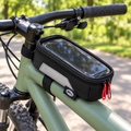 Bell Top Tube Phone Bag mounted on a bicycle at a park path; lifestyle illustration, phone and bicycle not included