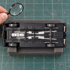 Illustrative underside inspection of an assembled Black Beauty model on a padded hobby mat; inspection props are not included.