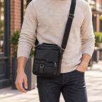 Black textured crossbody bag worn with its adjustable shoulder strap