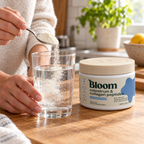 Adding unflavored Bloom colostrum and collagen powder to a glass of water