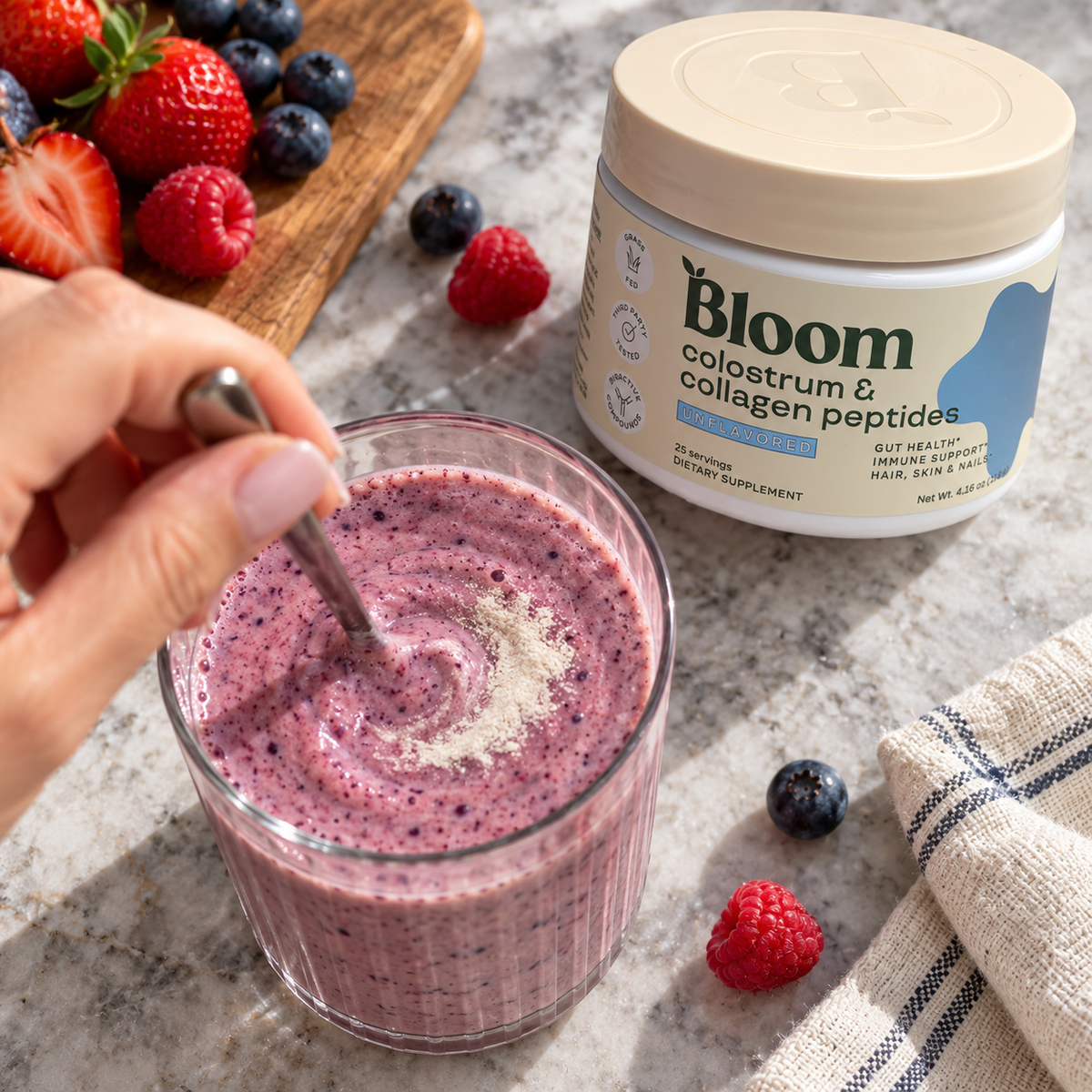 Stirring unflavored Bloom powder into a berry smoothie