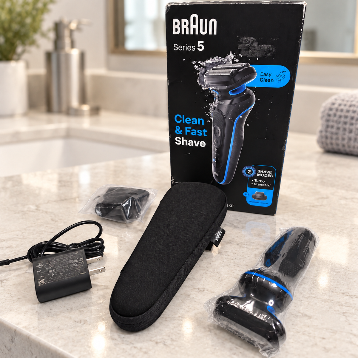 Braun 5118s boxed kit on pale stone bathroom vanity; illustrative background