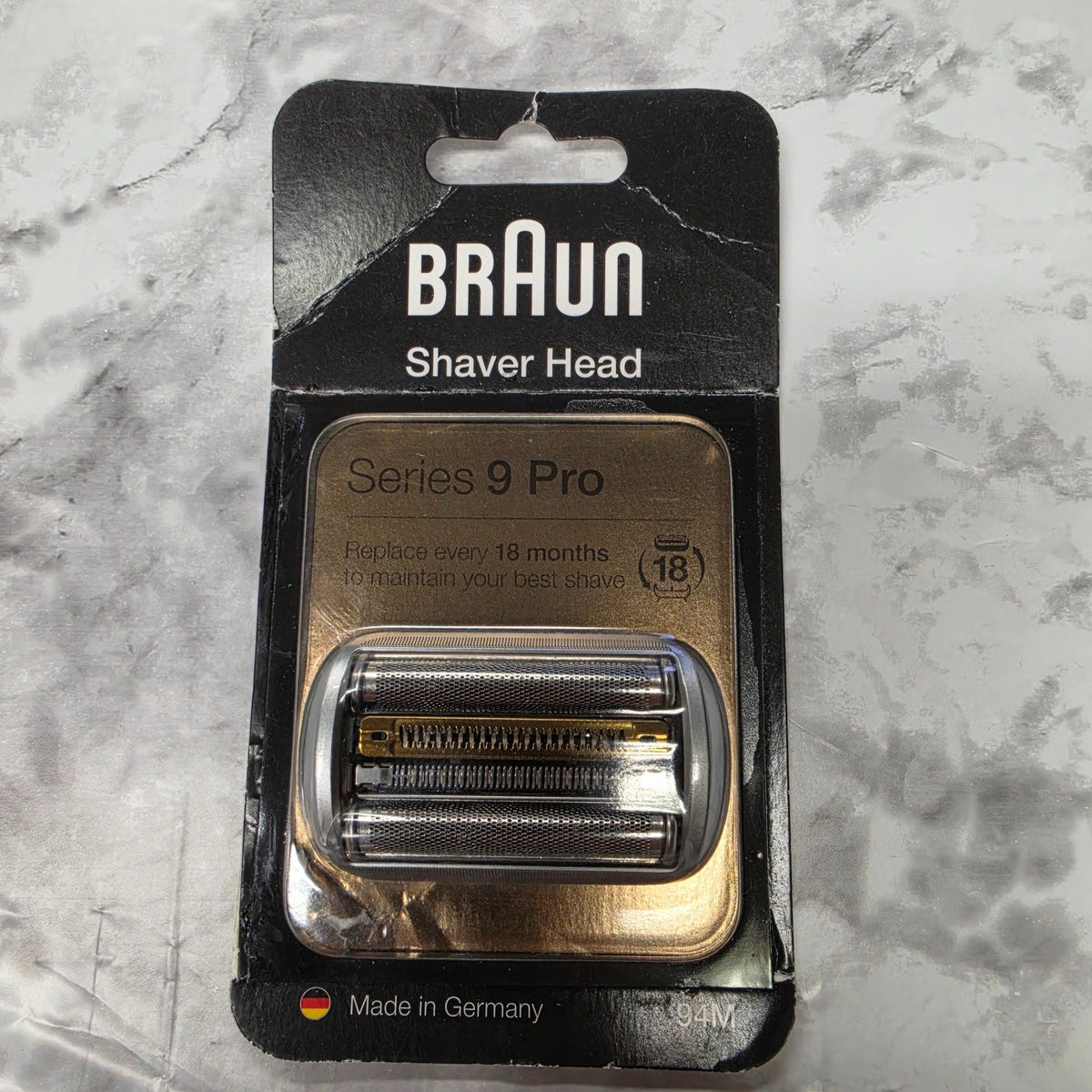 Actual new Braun Series 9 Pro 94M shaver head in original blister packaging with visible creasing and wear on the outer card