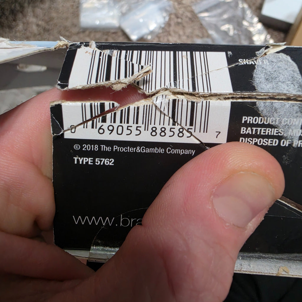 Original torn box barcode label showing UPC 069055885857 and packaging damage