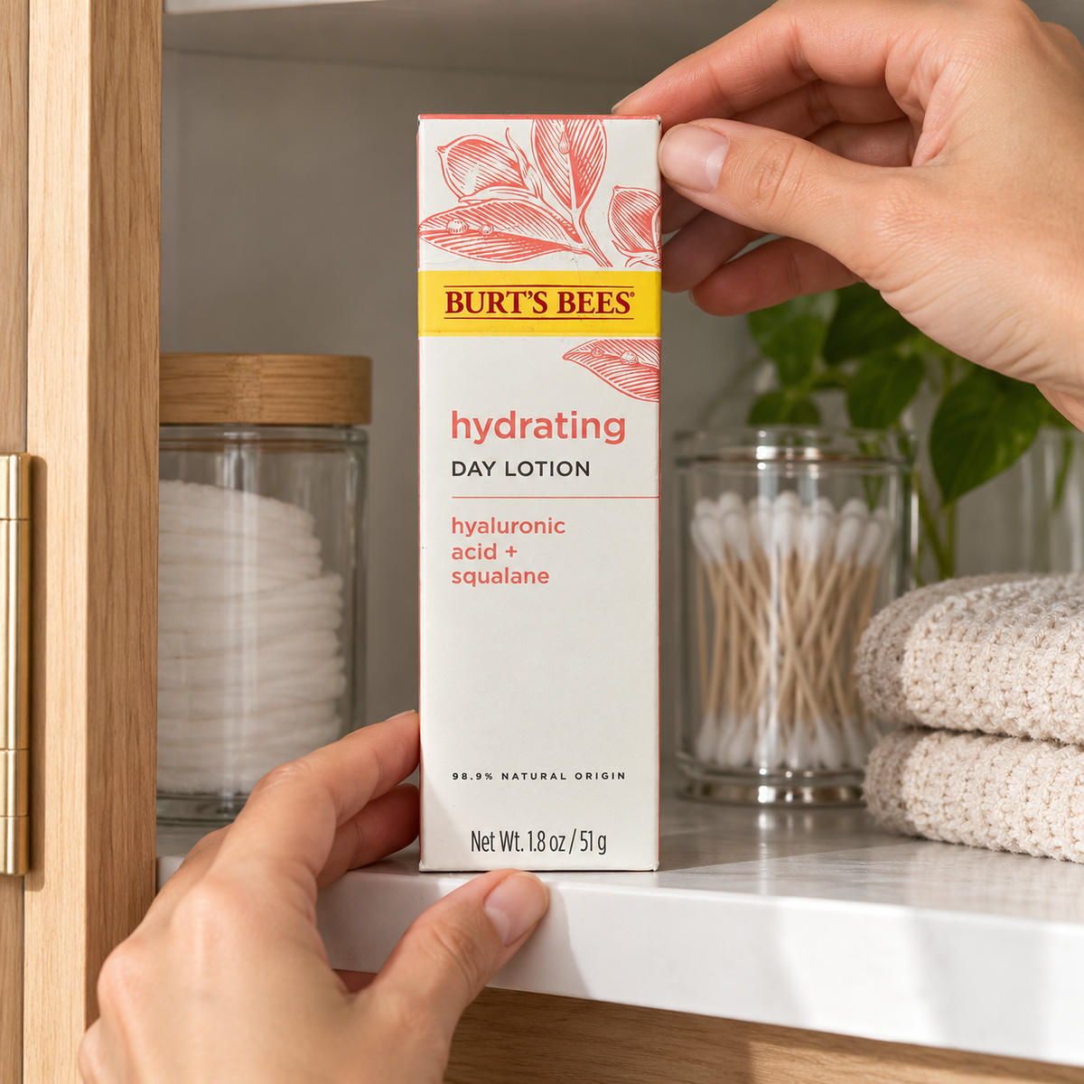 Adult hands placing Burt's Bees Hydrating Day Lotion carton on a cabinet shelf, AI-assisted illustration