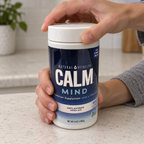 Hands opening a CALM Mind Unflavored drink-mix tub.
