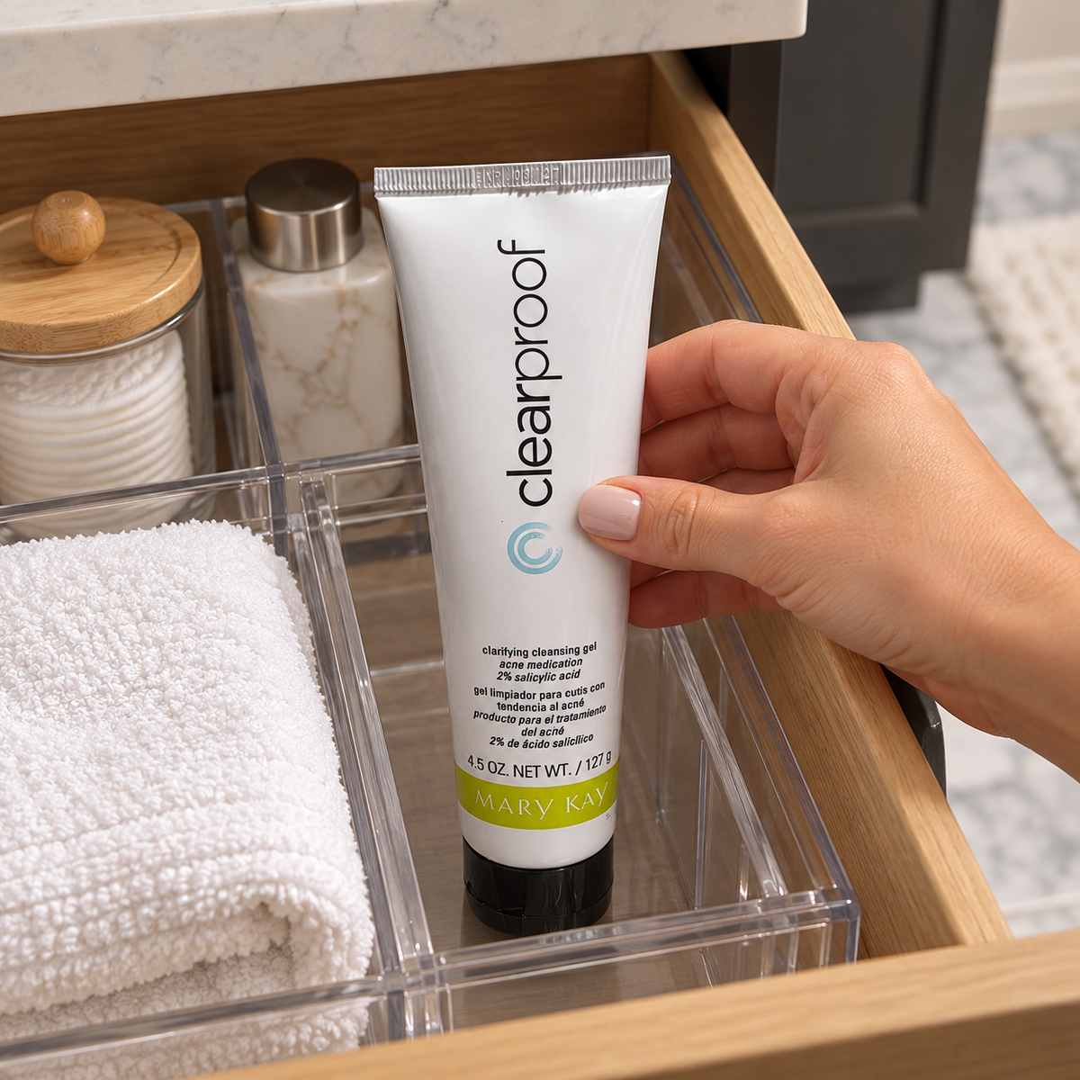 Placing a capped Clear Proof cleansing gel tube in a bathroom drawer organizer