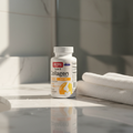 Collagen bottle on a bathroom counter with towels