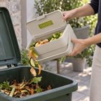 Emptying a Joseph Joseph Compo caddy into a larger outdoor food-scrap bin