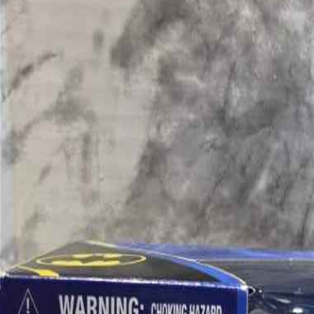 Actual stocked product photo detail of DC 5-figure pack choking warning and ages 3 plus marking.