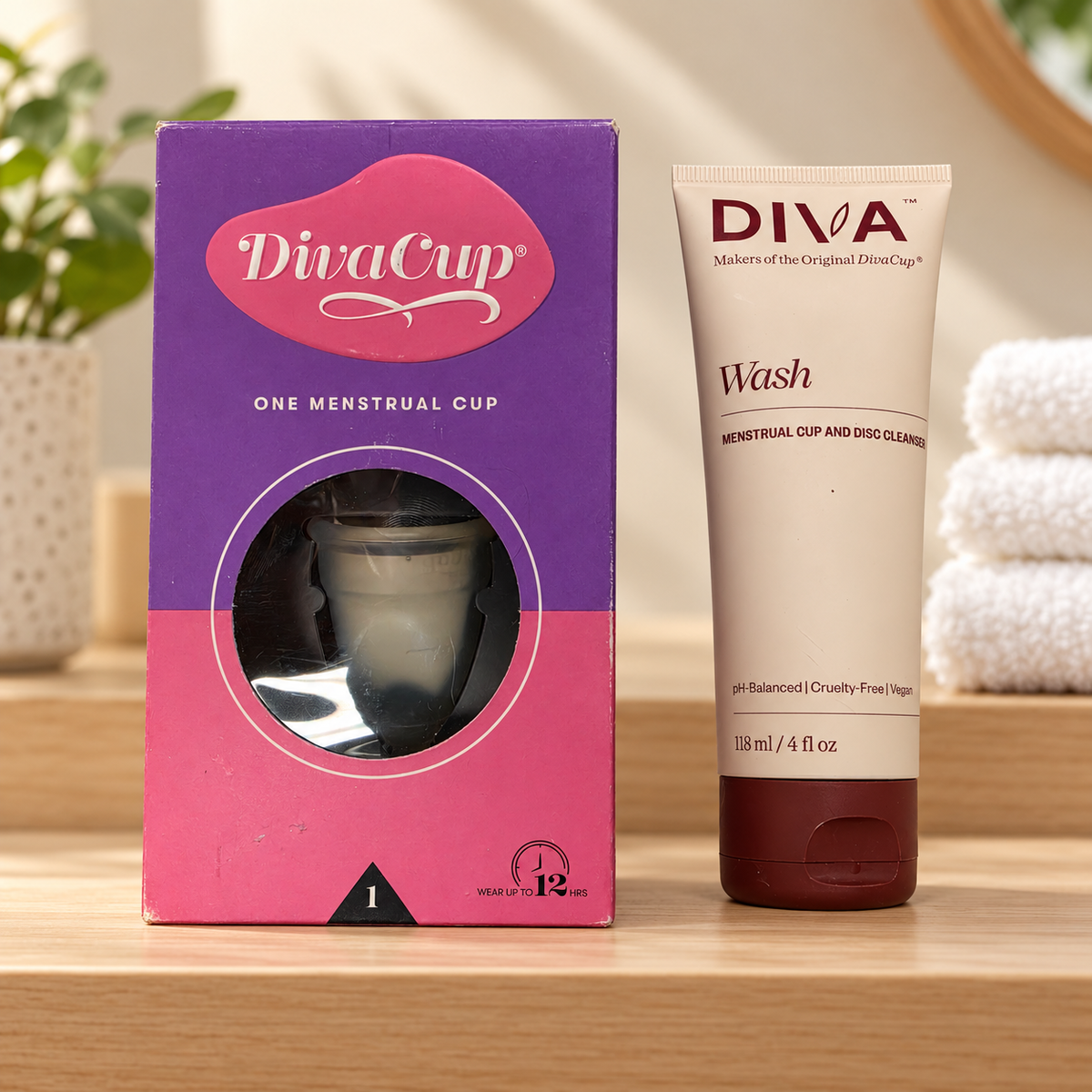 DivaCup Model 1 and DIVA Wash 118 mL on a towel shelf; lifestyle illustration, props not included