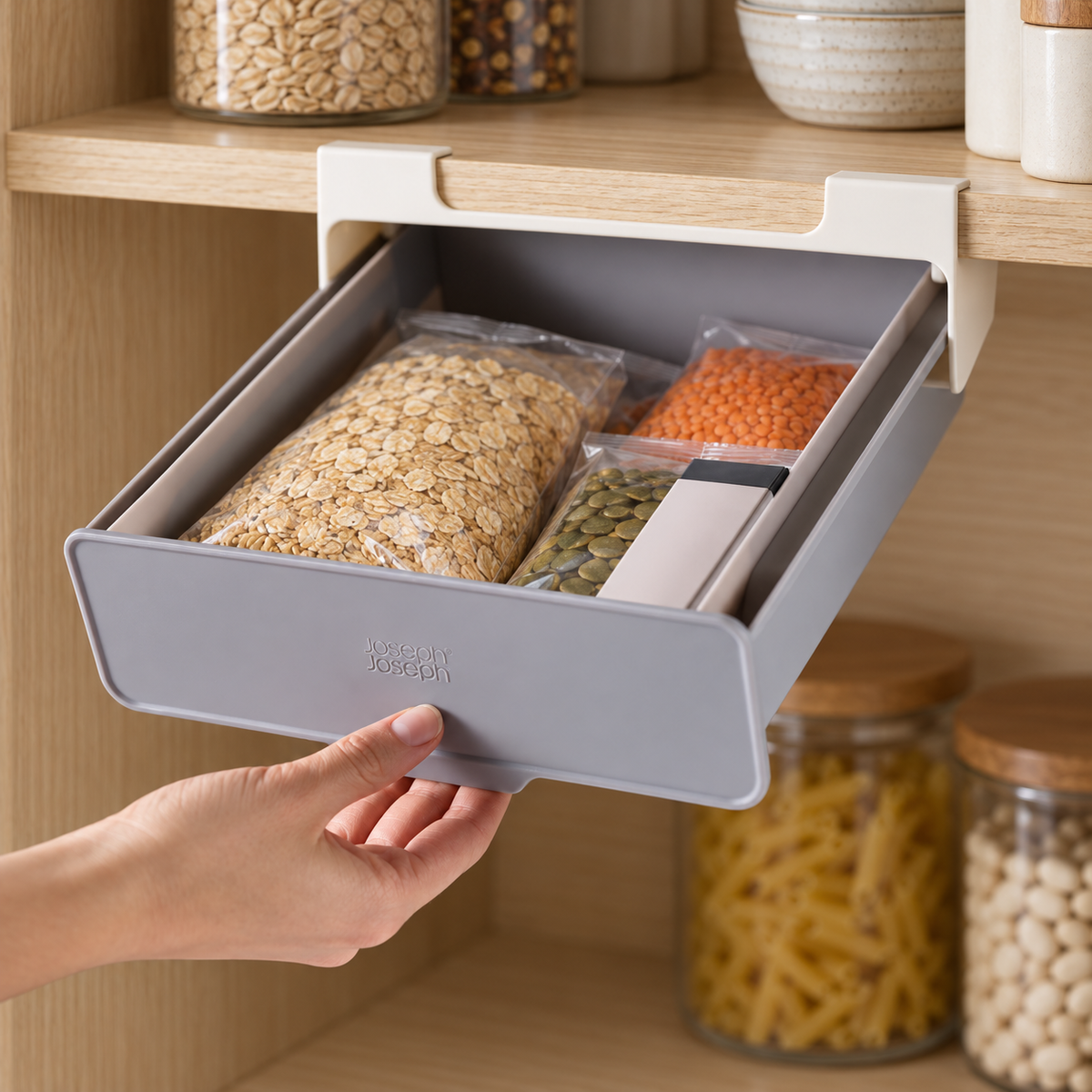 CupboardStore drawer pulled open to access small pantry packets; contents are props