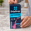 AI-generated illustrative scene of adult hands peeling the rear circular closure sticker from a DripDrop Bold Variety 8-count carton.