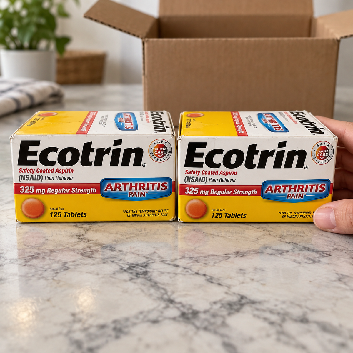 Two Ecotrin 325 mg aspirin boxes side by side, with an adult hand checking the two-box set.
