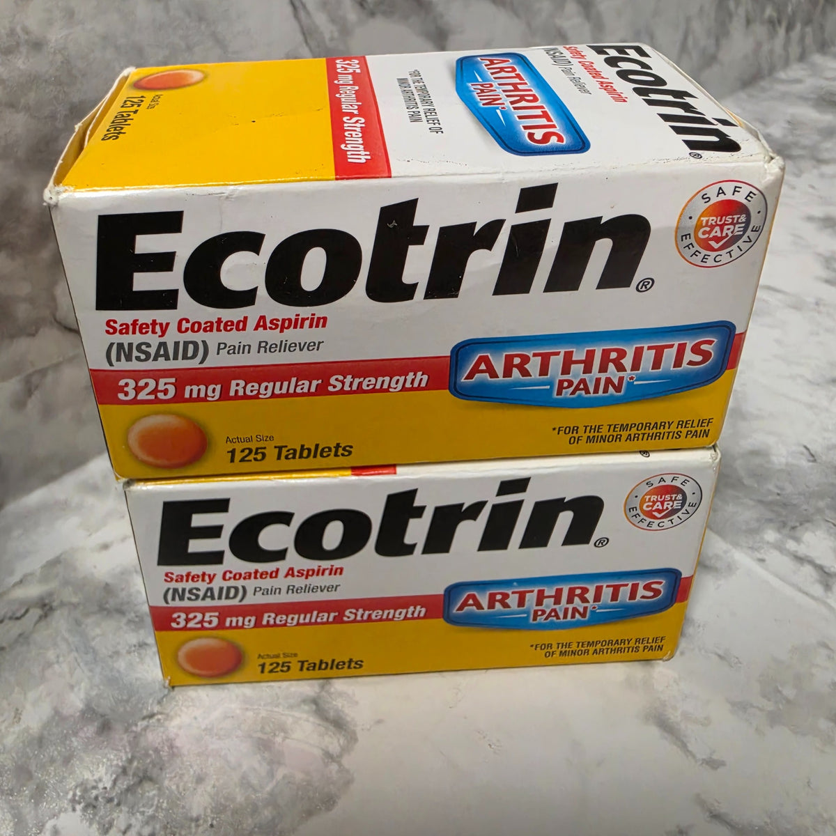 Two boxes of Ecotrin 325 mg Regular Strength Safety Coated Aspirin, 125 tablets each, showing outer-carton wear.