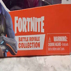 Actual stocked product photo detail of Fortnite Battle Royale Collection title and choking hazard warning.