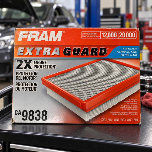 FRAM CA9838 Extra Guard box on an automotive workshop cart lifestyle scene