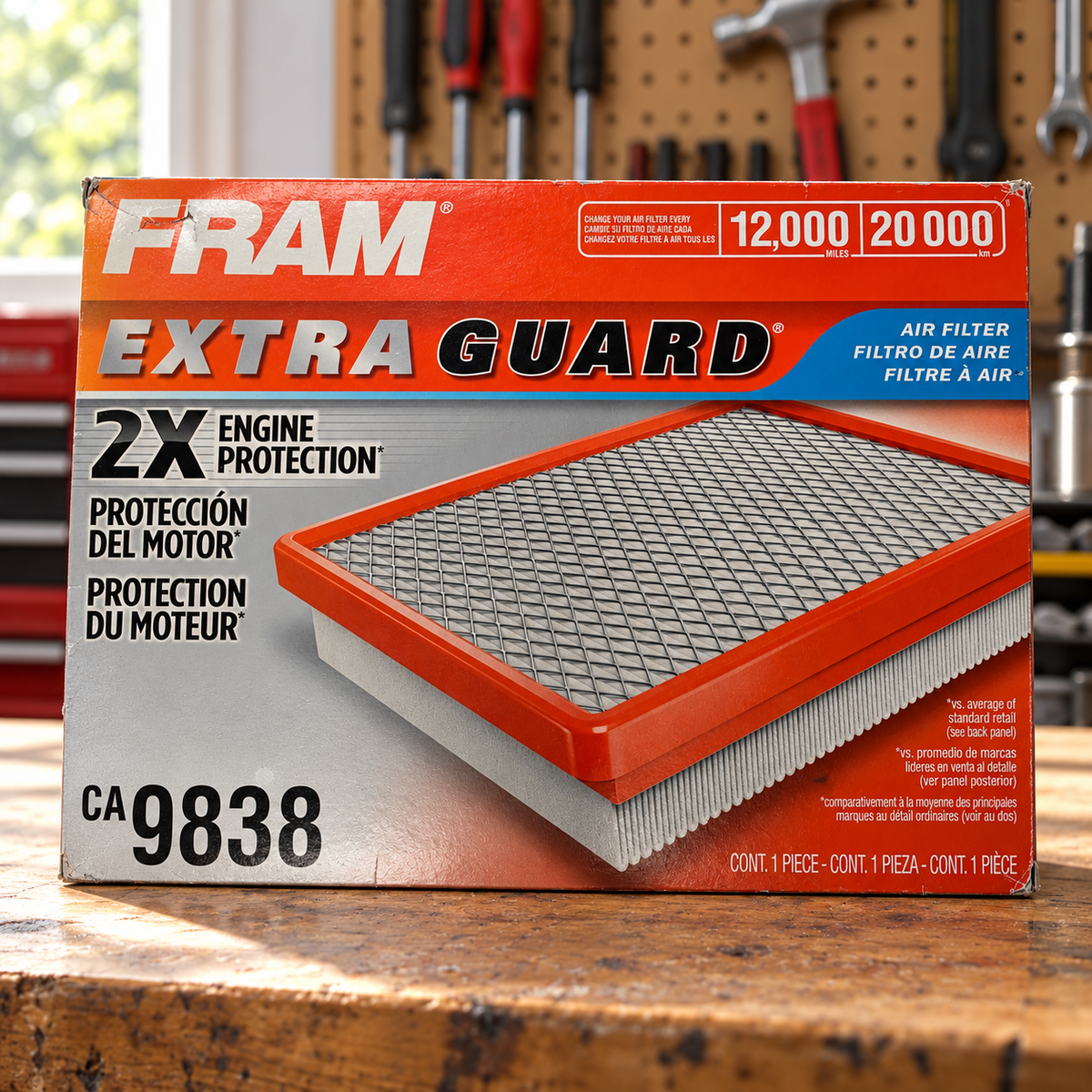 FRAM CA9838 Extra Guard box in a home garage lifestyle scene; AI-staged composite.